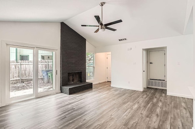 7103 Treasure Cv Unit B, Austin, TX 78745 - unfurnished living room featuring a ceiling fan, wood finished floors, a brick fireplace, baseboards, and high vaulted ceiling