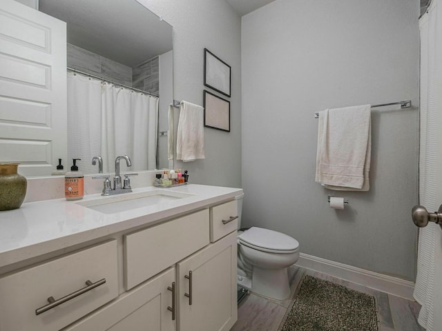 114 Loysoya St, Bastrop, TX 78602 - full bath with vanity, toilet, baseboards, wood finished floors, and curtained shower