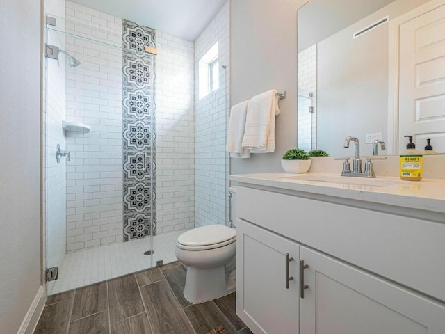114 Loysoya St, Bastrop, TX 78602 - bathroom featuring vanity, toilet, a stall shower, and wood finished floors