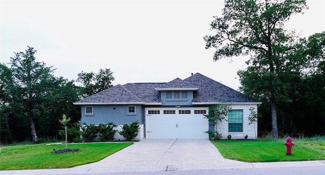 114 Loysoya St, Bastrop, TX 78602 - view of front facade with a front lawn, concrete driveway, an attached garage, and a shingled roof