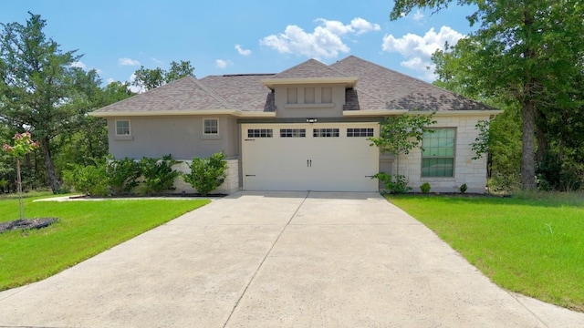114 Loysoya St, Bastrop, TX 78602 - view of front of property with a shingled roof, a front lawn, an attached garage, and concrete driveway