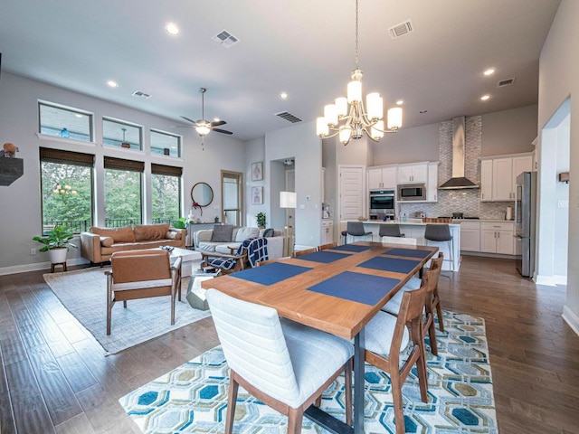 114 Loysoya St, Bastrop, TX 78602 - dining area with a chandelier, ceiling fan, recessed lighting, dark wood-style floors, and a towering ceiling