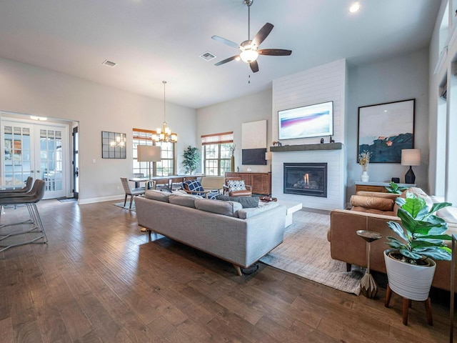 114 Loysoya St, Bastrop, TX 78602 - living area featuring dark wood-style flooring, a large fireplace, a ceiling fan, a chandelier, and recessed lighting