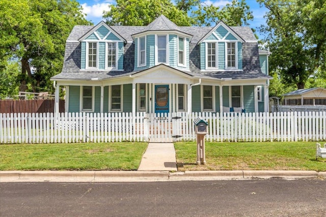 1223 Cecelia St, Taylor, TX 76574 - view of front facade featuring a porch, roof with shingles, and a fenced front yard