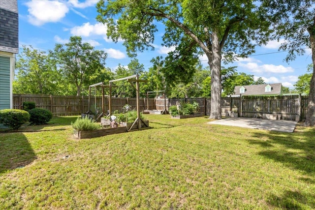 1223 Cecelia St, Taylor, TX 76574 - view of yard featuring a garden and a patio