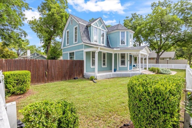 1223 Cecelia St, Taylor, TX 76574 - view of front facade with a porch, a shingled roof, and a gambrel roof