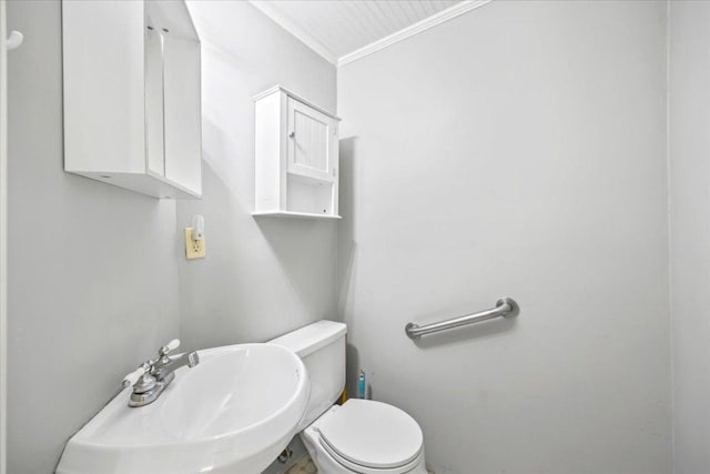 1223 Cecelia St, Taylor, TX 76574 - half bath featuring crown molding, toilet, and a sink