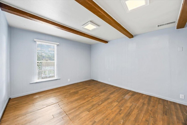 1223 Cecelia St, Taylor, TX 76574 - unfurnished room with beam ceiling and wood finished floors