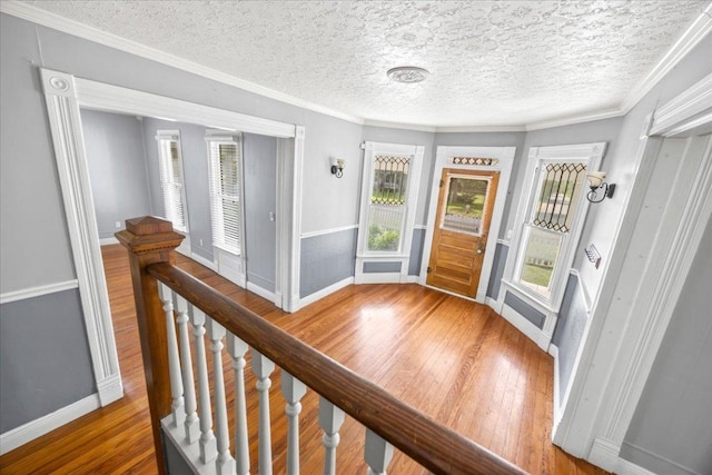 1223 Cecelia St, Taylor, TX 76574 - entrance foyer with wood-type flooring, a textured ceiling, and ornamental molding