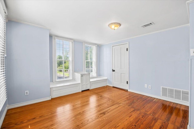 1223 Cecelia St, Taylor, TX 76574 - empty room featuring light wood finished floors and ornamental molding