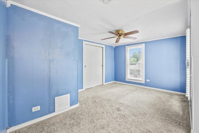 1223 Cecelia St, Taylor, TX 76574 - unfurnished bedroom featuring carpet flooring, crown molding, ceiling fan, and a closet