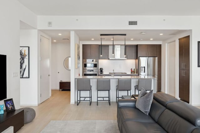 301 W Ave Unit 3802, Austin, TX 78701 - living room with light wood-style floors and recessed lighting