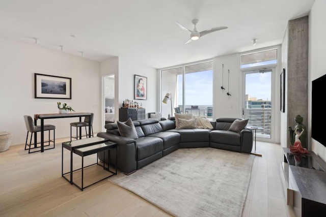 301 W Ave Unit 3802, Austin, TX 78701 - living room featuring light wood-style floors, a ceiling fan, and a wall of windows