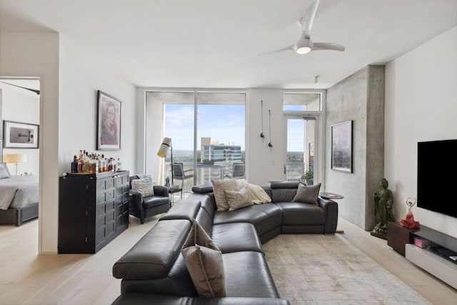 301 W Ave Unit 3802, Austin, TX 78701 - living area with healthy amount of natural light, a wall of windows, light wood-style flooring, ceiling fan, and a dry bar