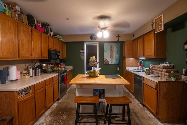 178 Ann Powell Rd, Smithville, TX 78957 - kitchen with range with two ovens, black microwave, dishwasher, light countertops, and ceiling fan