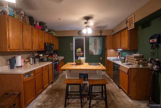 178 Ann Powell Rd, Smithville, TX 78957 - kitchen featuring range with two ovens, black microwave, a sink, dishwasher, and ceiling fan