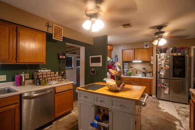 178 Ann Powell Rd, Smithville, TX 78957 - kitchen featuring appliances with stainless steel finishes, ceiling fan, brown cabinets, and wood counters