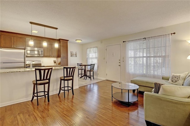 910 Duncan Ln Unit 60, Austin, TX 78705 - living area featuring wood finished floors and a textured ceiling