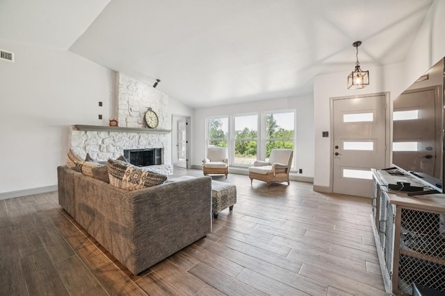 9600 Claxton Dr, Austin, TX 78736 - living room with vaulted ceiling, wood finished floors, and a fireplace
