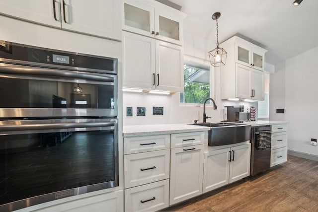 9600 Claxton Dr, Austin, TX 78736 - kitchen featuring double oven, dishwashing machine, a sink, dark wood-style flooring, and light countertops