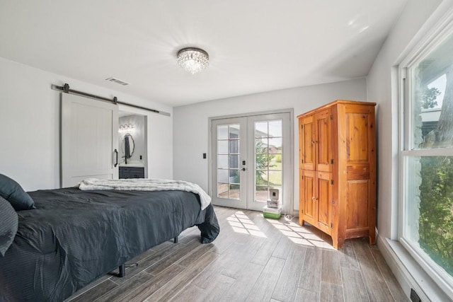 9600 Claxton Dr, Austin, TX 78736 - bedroom featuring access to exterior, french doors, multiple windows, and wood finished floors