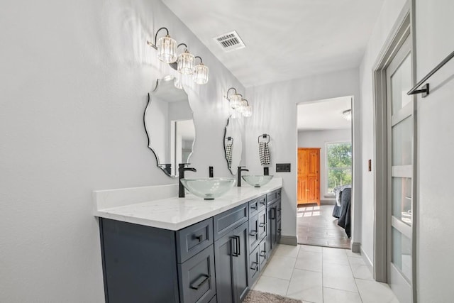 9600 Claxton Dr, Austin, TX 78736 - bathroom with double vanity, tile patterned floors, and baseboards