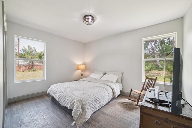 9600 Claxton Dr, Austin, TX 78736 - bedroom featuring multiple windows and wood finished floors