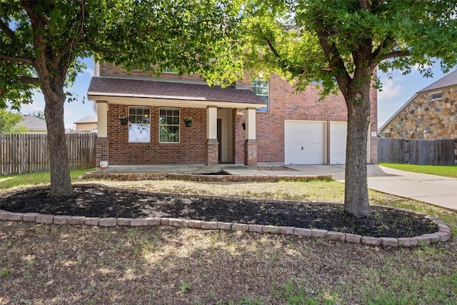 383 Spring Dr, Kyle, TX 78640 - obstructed view of property with concrete driveway, an attached garage, brick siding, and a porch
