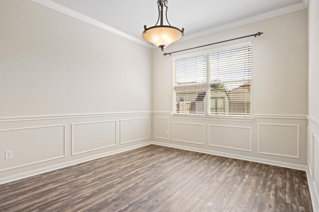 383 Spring Dr, Kyle, TX 78640 - empty room featuring crown molding, dark wood-type flooring, a decorative wall, and a wainscoted wall