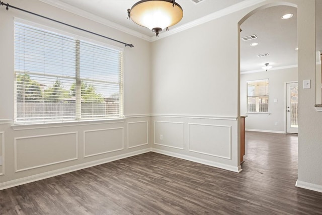 383 Spring Dr, Kyle, TX 78640 - unfurnished room with arched walkways, crown molding, dark wood finished floors, wainscoting, and a decorative wall