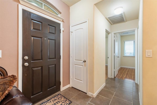 620 Allens Creek Way, Round Rock, TX 78664 - foyer featuring dark tile patterned flooring and baseboards