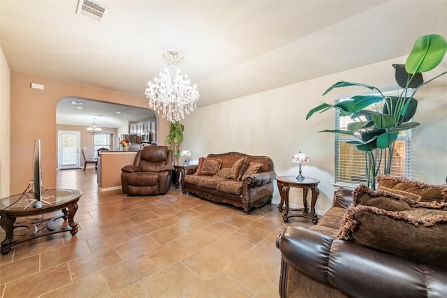 620 Allens Creek Way, Round Rock, TX 78664 - living room with a chandelier, arched walkways, and light tile patterned floors
