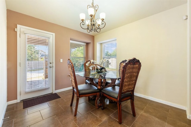 620 Allens Creek Way, Round Rock, TX 78664 - dining room with a chandelier and dark tile patterned flooring