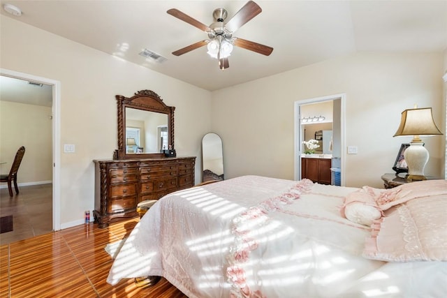 620 Allens Creek Way, Round Rock, TX 78664 - bedroom with wood finished floors, ensuite bathroom, vaulted ceiling, and ceiling fan