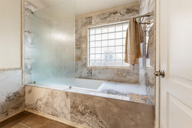 620 Allens Creek Way, Round Rock, TX 78664 - bathroom with plenty of natural light, a tub with marble appearance, a shower, and tile patterned floors