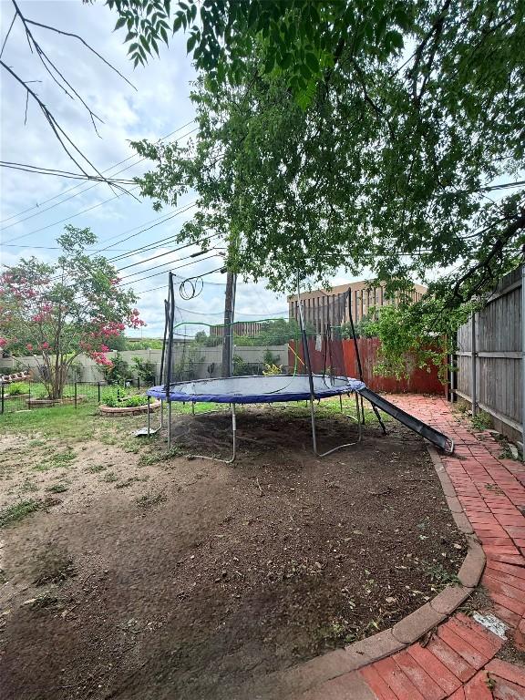7707 Eastcrest Dr, Austin, TX 78752 - view of playground with a trampoline and a fenced backyard