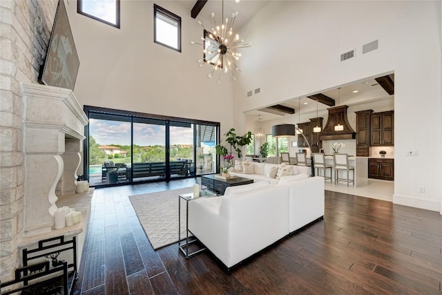 8100 Magnolia Ridge Cv, Austin, TX 78738 - living area with a towering ceiling, dark wood-style flooring, and a chandelier