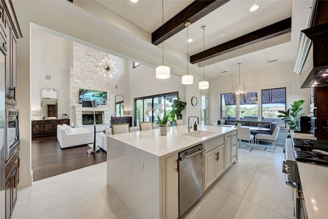 8100 Magnolia Ridge Cv, Austin, TX 78738 - kitchen with open floor plan, stainless steel dishwasher, beam ceiling, a fireplace, and a high ceiling