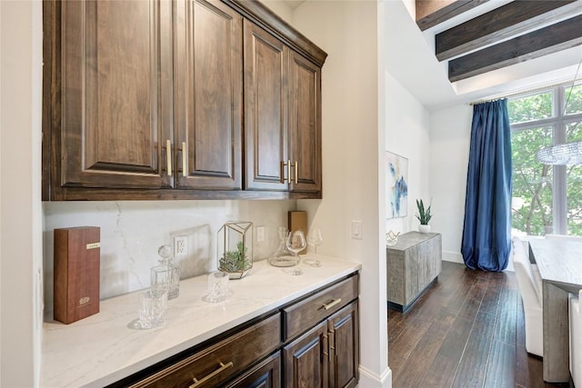 8100 Magnolia Ridge Cv, Austin, TX 78738 - kitchen with dark wood-style flooring, dark brown cabinets, light stone countertops, and baseboards