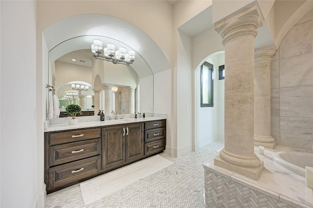 8100 Magnolia Ridge Cv, Austin, TX 78738 - full bath with ornate columns, vanity, a garden tub, and a chandelier