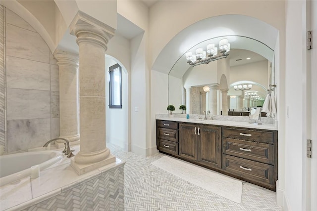 8100 Magnolia Ridge Cv, Austin, TX 78738 - full bathroom with decorative columns, vanity, a garden tub, and a chandelier