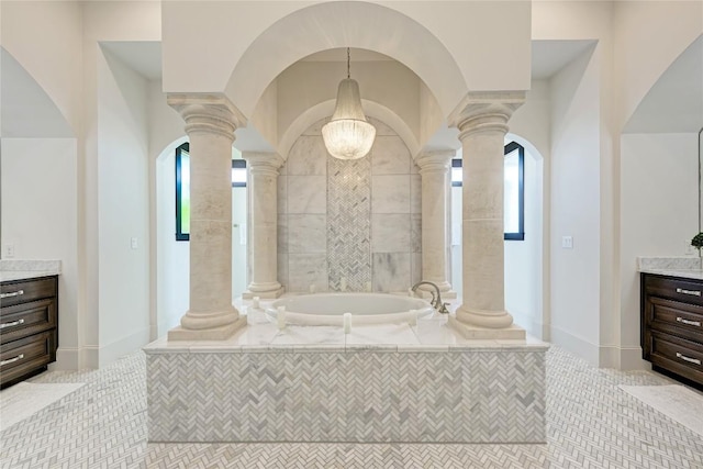 8100 Magnolia Ridge Cv, Austin, TX 78738 - full bathroom with ornate columns, vanity, a garden tub, and plenty of natural light