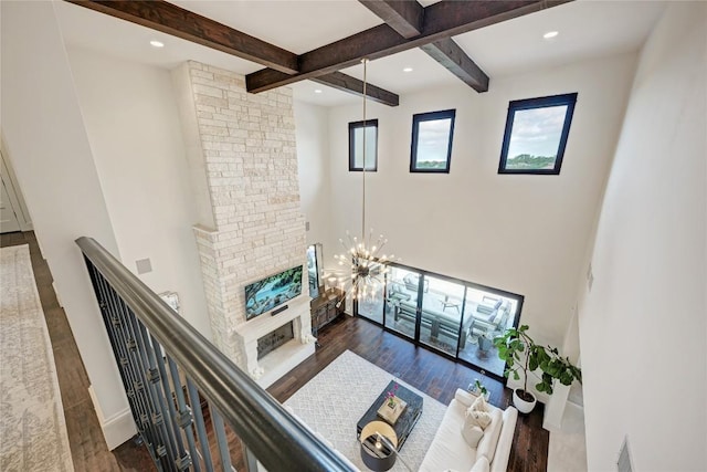 8100 Magnolia Ridge Cv, Austin, TX 78738 - living room featuring beamed ceiling, a fireplace, wood finished floors, a towering ceiling, and recessed lighting