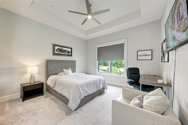 8100 Magnolia Ridge Cv, Austin, TX 78738 - carpeted bedroom featuring a tray ceiling, baseboards, and a ceiling fan