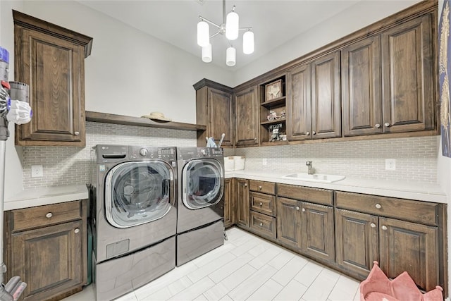 8100 Magnolia Ridge Cv, Austin, TX 78738 - laundry room with cabinet space, independent washer and dryer, and a chandelier