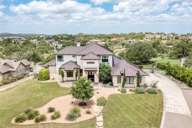 8100 Magnolia Ridge Cv, Austin, TX 78738 - view of front of house with a standing seam roof, metal roof, stone siding, and a front lawn