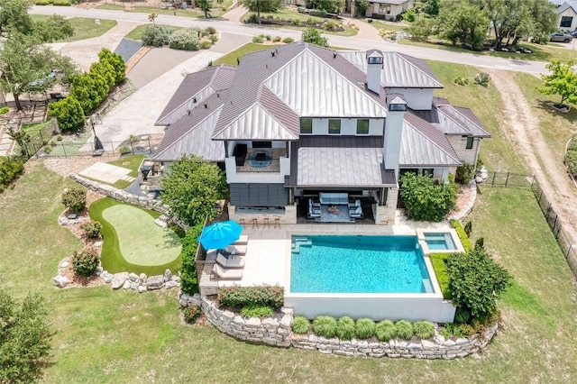 8100 Magnolia Ridge Cv, Austin, TX 78738 - rear view of property with a patio, a pool with connected hot tub, metal roof, a standing seam roof, and board and batten siding