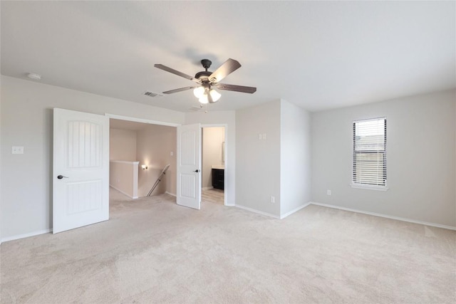 9001 Edmundsbury Dr, Austin, TX 78747 - unfurnished bedroom with light carpet, ensuite bathroom, and a ceiling fan