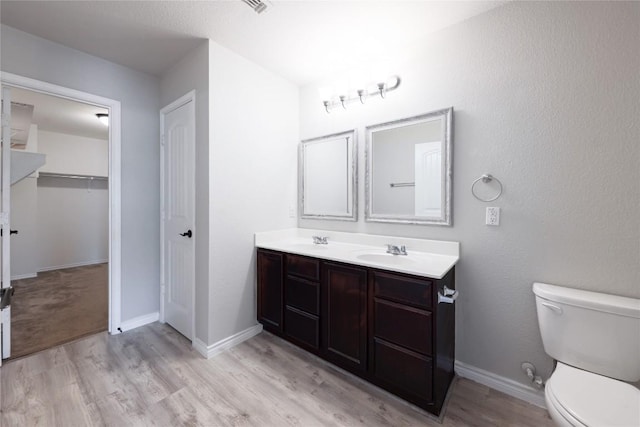 9001 Edmundsbury Dr, Austin, TX 78747 - full bathroom featuring double vanity, wood finished floors, and a closet
