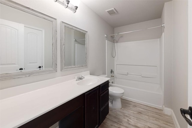 9001 Edmundsbury Dr, Austin, TX 78747 - full bath with toilet, vanity, shower / tub combination, and wood finished floors